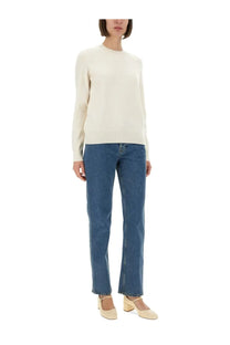 Burberry women’s straight fit jeans blue paired with a cream-colored long-sleeved knit sweater with a crew neckline
