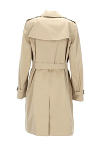 Beige trench coat with belted waist and classic collar from Burberry women’s trench heritage Kensington collection