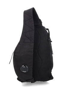Black quilted nylon shoulder bag with mesh side panel and circular logo patch by C.P. Company men’s backpack
