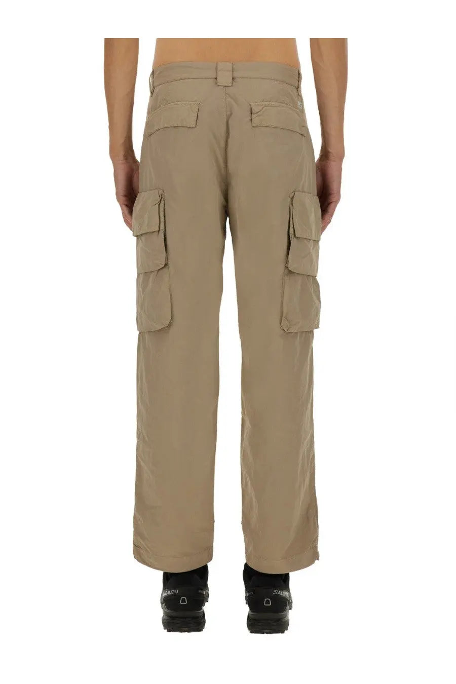Beige c.p. company men’s cargo pants with multiple flap pockets and a straight-leg cut in durable fabric