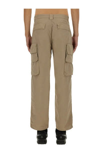 Beige c.p. company men’s cargo pants with multiple flap pockets and a straight-leg cut in durable fabric