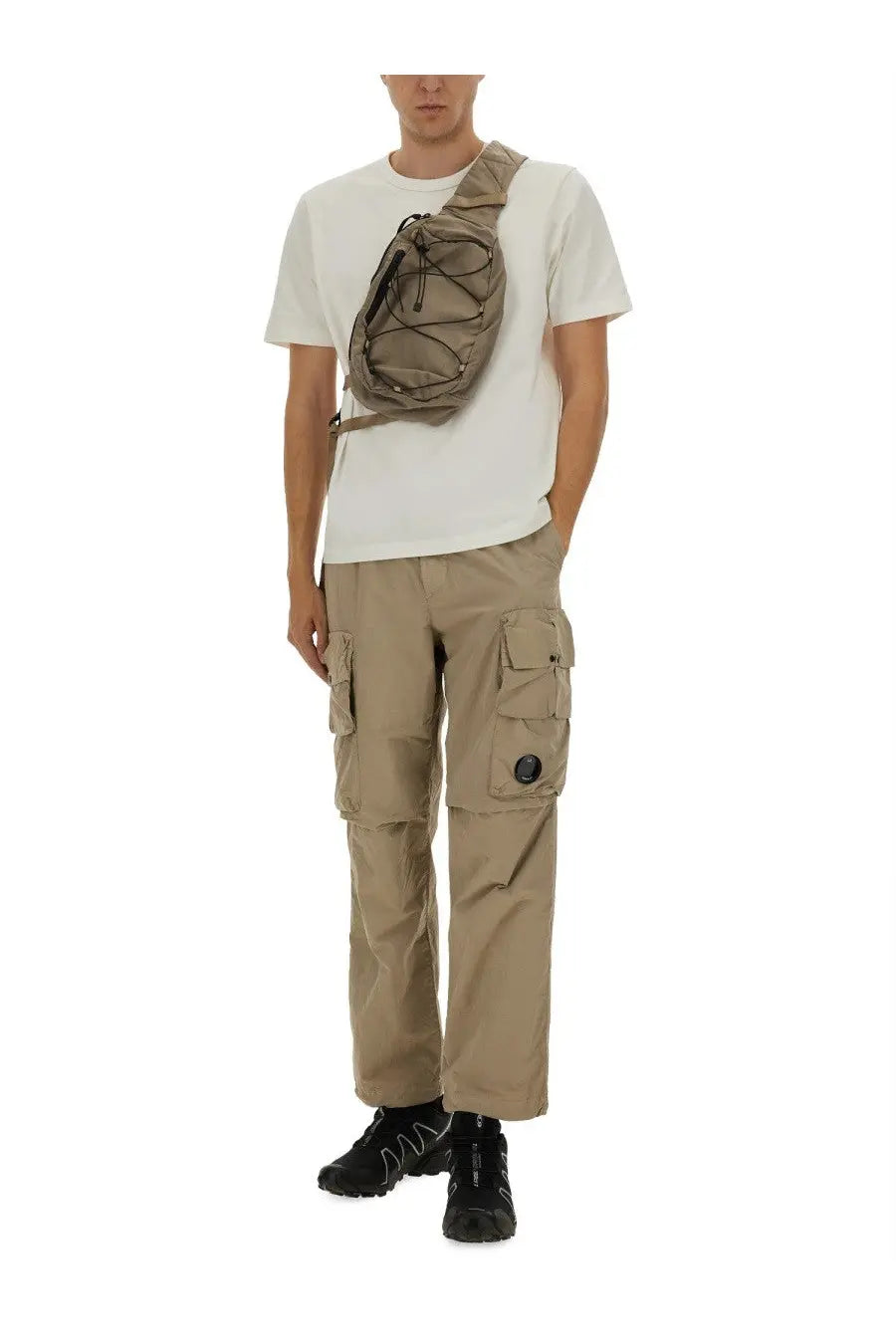 Beige tactical style crossbody bag with mesh pattern and adjustable strap featured with c.p. company men’s cargo pants beige