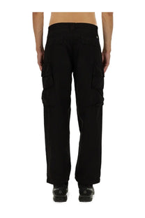Black cargo pants by c.p. company for men with multiple pockets and a straight-leg cut in durable fabric