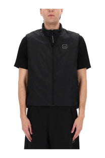 Black c.p. company men’s gilet with high collar front zipper and small square logo patch on chest