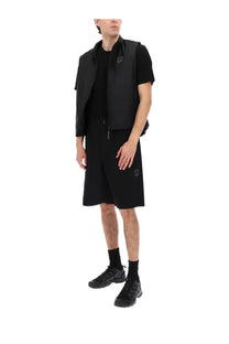 C P Company men’s black sleeveless vest with subtle logo patches on the chest and lower left leg