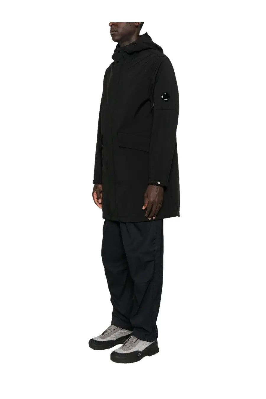 C.P. Company men’s black hooded parka with a subtle circular logo on the upper left sleeve