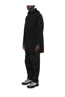 C.P. Company men’s black hooded parka with a subtle circular logo on the upper left sleeve