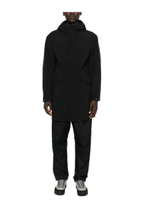C.p. company men’s black hooded parka with a sleek minimalist trench coat design and subtle sleeve branding