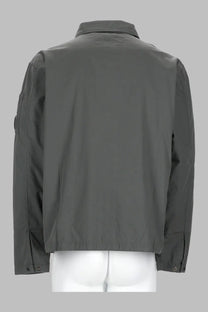 Dark gray c.p. company men’s overshirt with structured collar and buttoned cuffs in durable utility fabric