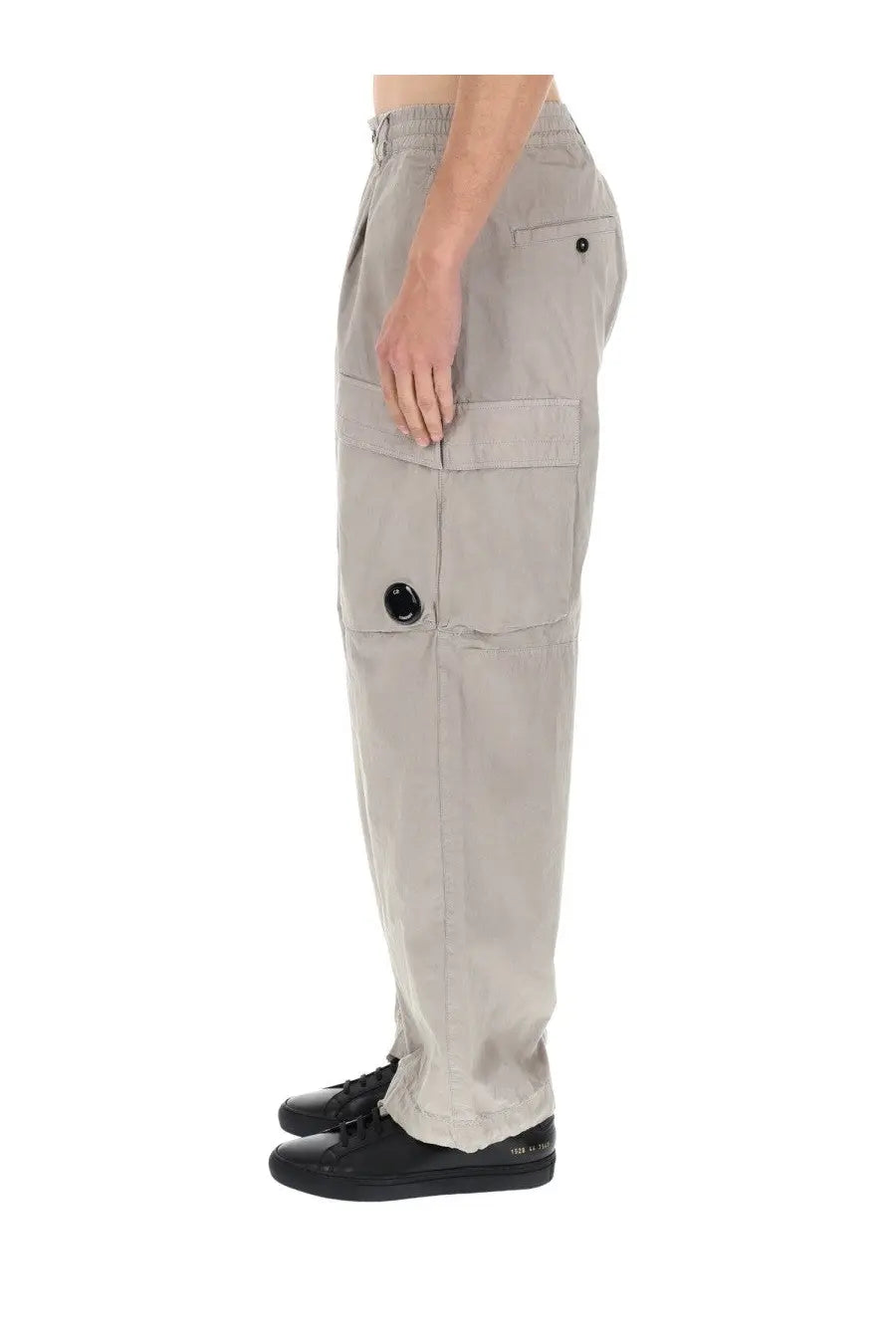 Beige cargo pants with multiple pockets and black circular button accents from c.p. company men’s pantalone cargo con patch
