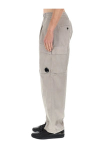 Beige cargo pants with multiple pockets and black circular button accents from c.p. company men’s pantalone cargo con patch
