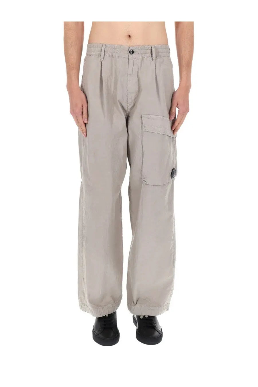 C.P. Company men’s beige cargo pants with a relaxed fit feature multiple pockets and button closures