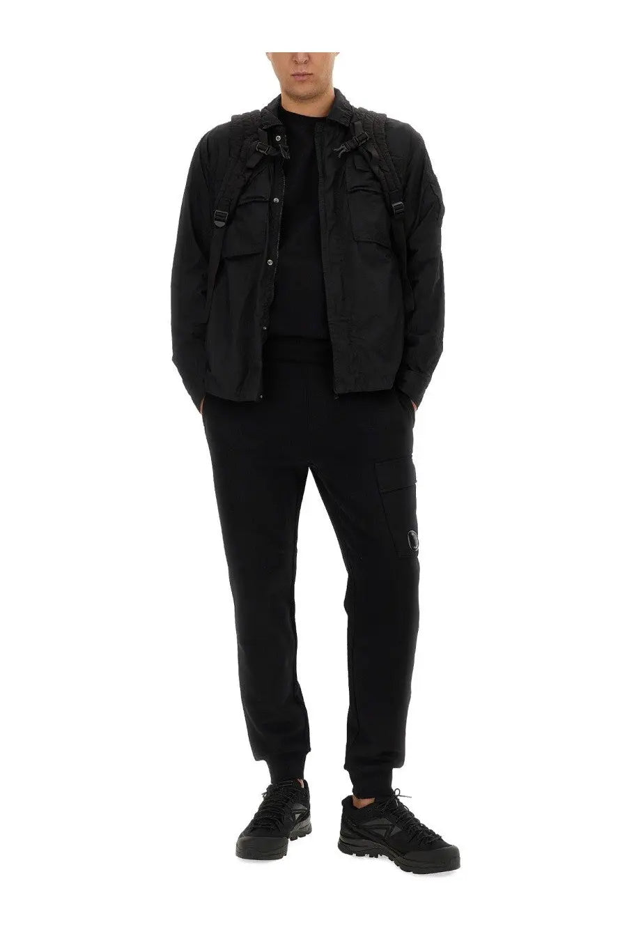 Black c.p. company men’s utility jacket with multiple pockets and adjustable straps for versatile wear
