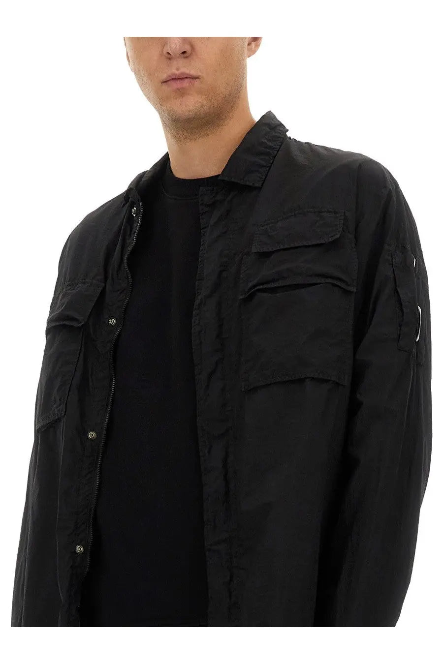 Black utility-style C.P. Company men’s shirt with multiple pockets and front zipper for practical everyday wear
