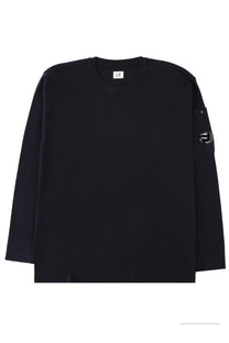Black long-sleeved crewneck sweatshirt with subtle textured fabric and circular logo patch on left sleeve by c.p. company