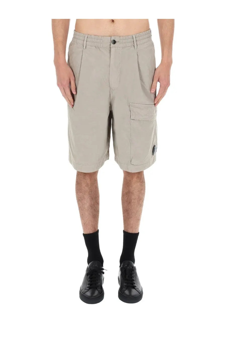Beige c.p. company men’s cargo shorts with button closure side pockets made from durable fabric