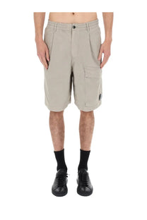 Beige c.p. company men’s cargo shorts with button closure side pockets made from durable fabric