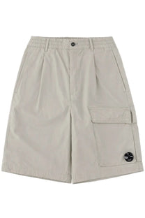 C.P. Company men’s beige cargo shorts with relaxed fit elastic waistband and large side pockets with black patches
