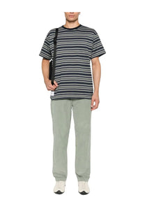 A short-sleeved t-shirt with navy blue gray and white horizontal stripes shown with c.p. company men’s green velvet chino pants