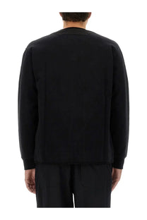 C.p. company men’s black zip sweatshirt with relaxed fit long sleeves and ribbed cuffs for casual wear