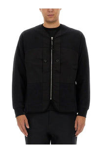C.P. Company men’s black utility jacket with central zipper and two front pockets featuring subtle chest branding