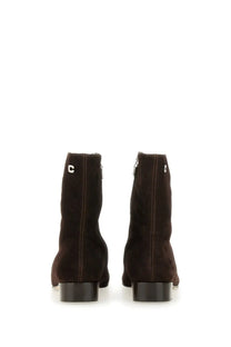 Dark brown suede ankle boots with low block heel and silver c logo on the back carel paris women’s aiglon brown