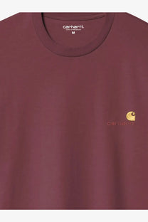 A maroon Carhartt Wip men’s American Script organic cotton crewneck t-shirt with gold embroidered logo on chest
