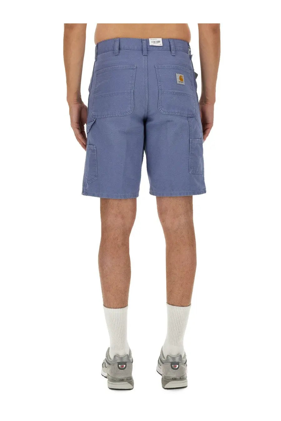 Back view of carhartt wip men’s columbia blue cargo bermuda shorts with multiple pockets and yellow logo patch
