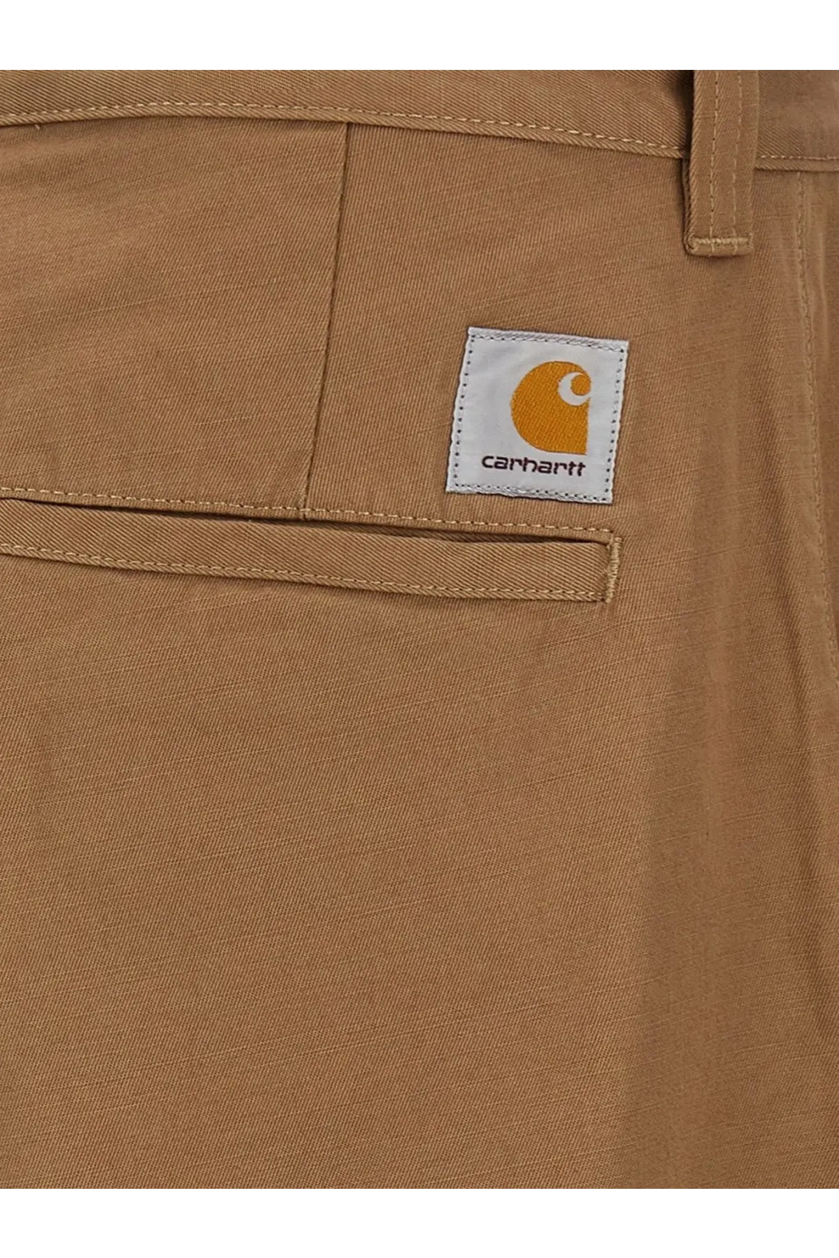 Carhartt Wip men’s bready cotton trousers beige featuring classic twill fabric and orange logo patch on front pocket