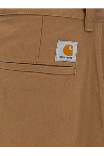 Carhartt Wip men’s bready cotton trousers beige featuring classic twill fabric and orange logo patch on front pocket