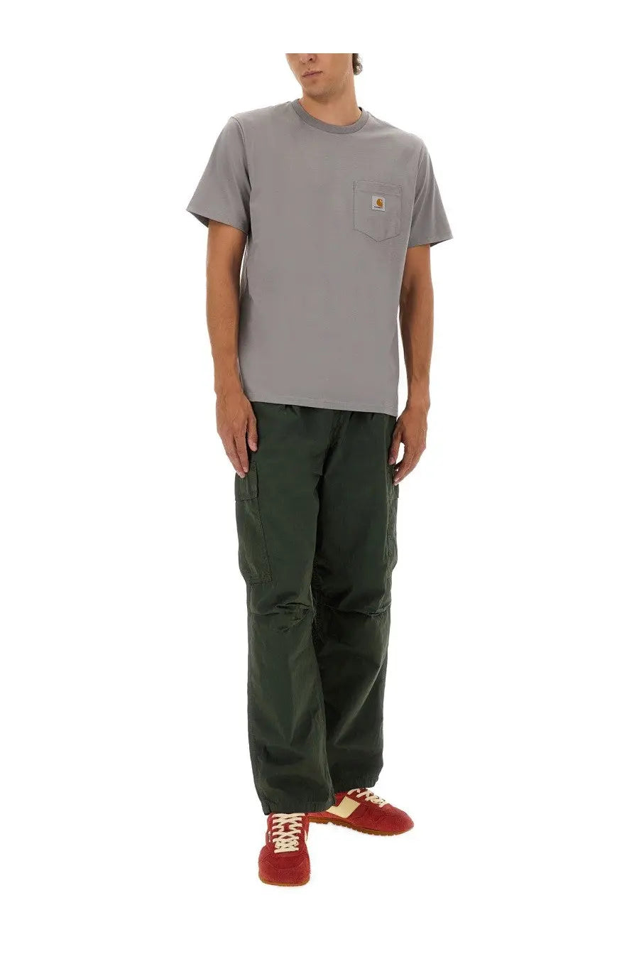 Gray carhartt t-shirt with chest pocket and logo patch paired with cole green carhartt wip men’s cargo pants