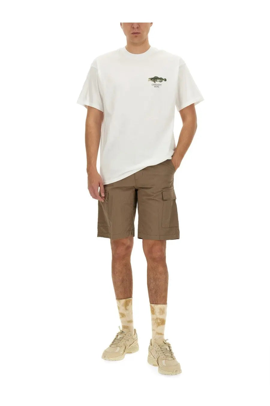 White crew neck cotton t shirt with small green fish graphic paired with beige carhartt wip men’s cotton bermuda shorts