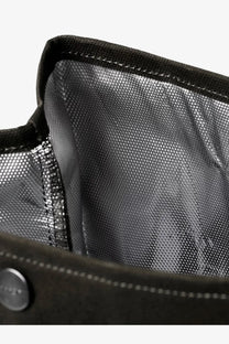 Black textured fabric lining with metallic sheen and metal button inside carhartt wip men’s dearborn canvas lunch bag green