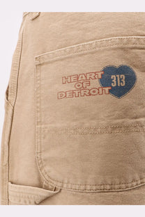 Beige denim jeans with heart of detroit patch in red and blue featuring 313 emblem carhartt wip mens organic cotton trousers