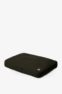 Black rectangular carhartt wip men’s dog bed with plush fabric and canvas cushion in green with logo tag