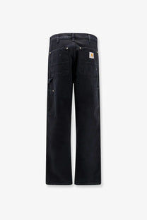 Back side of black carhartt wip men’s double knee denim trousers with multiple pockets and branded patch