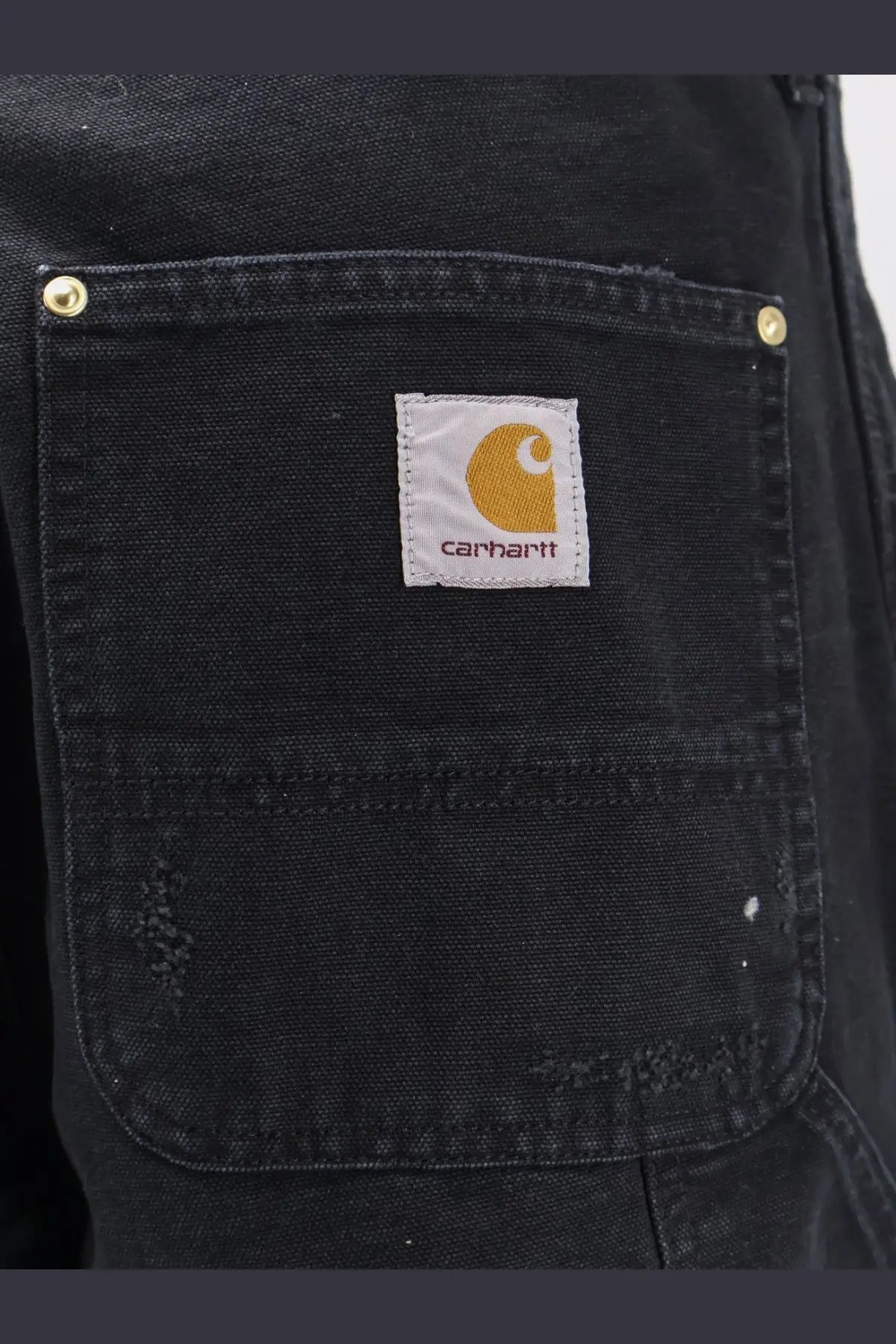 Black carhartt wip men’s double knee denim trousers with white label and red embroidered orange logo