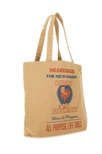 Carhartt Wip men’s beige canvas tote bag with orange and blue mastermade graphic text and circular design