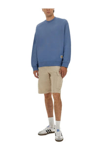 Carhartt Wip men’s jersey Hudson blue crewneck sweatshirt with a small tan logo patch on the lower left sleeve