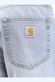 Back side of carhartt wip men’s landon light-wash denim jeans with classic pocket and white patch logo