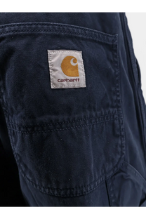 Dark blue carhartt wip men’s loose fit denim jeans with classic patch orange logo and white stitching on back pockets
