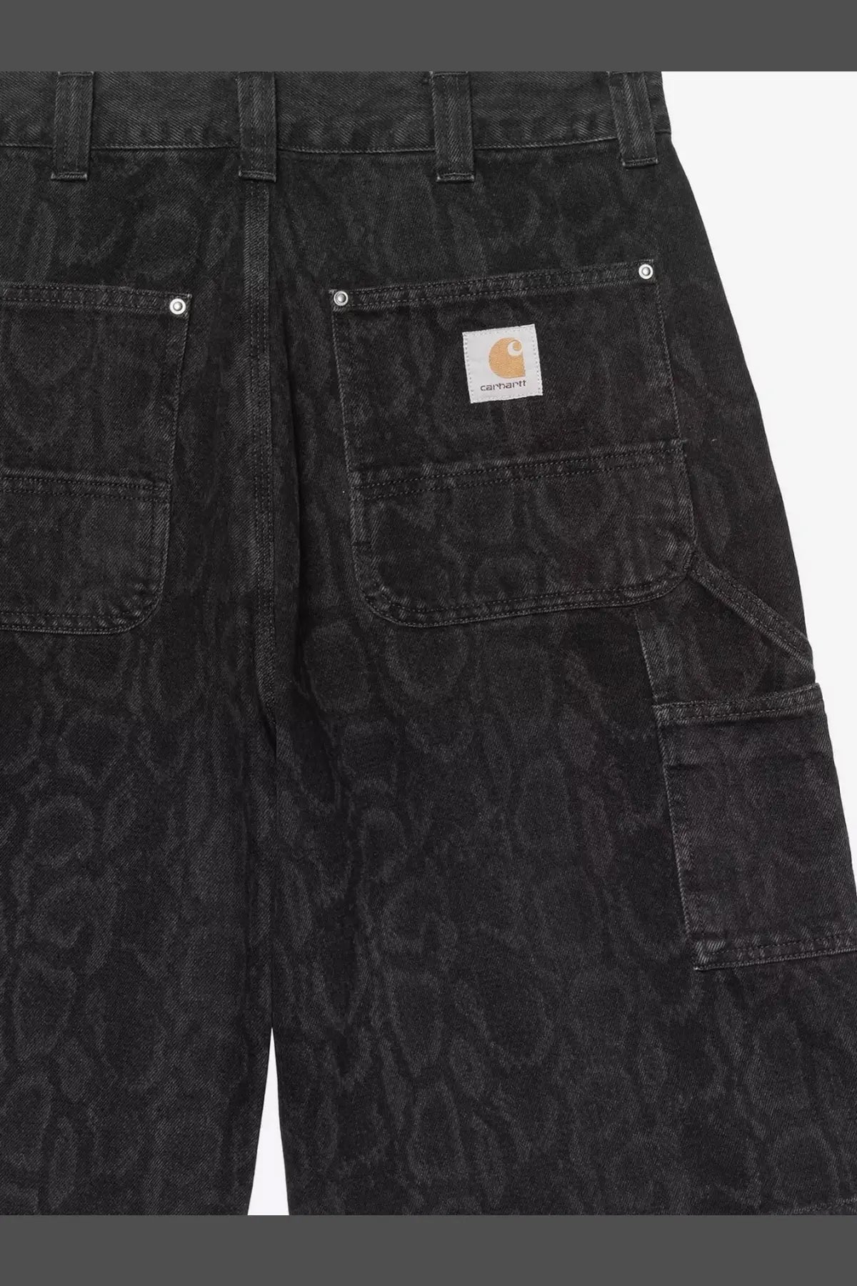 Back view of carhartt wip men’s og double knee black denim bermuda shorts with subtle snakeskin pattern and logo patch