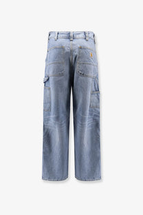Back view of light-wash denim cargo pants with multiple pockets and carhartt logo patch on the back right pocket
