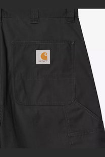 Black carhartt wip men’s postal dk cotton blend bermuda shorts featuring a white label with orange logo on front pocket