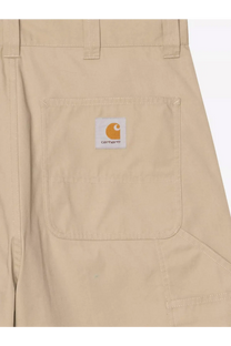 Beige carhartt wip men’s postal dk cotton blend bermuda shorts with white front pocket patch and orange logo