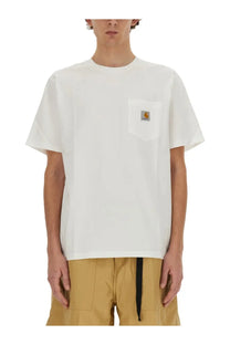Carhartt Wip men’s white t-shirt with chest pocket featuring the brand’s signature logo patch in cotton material