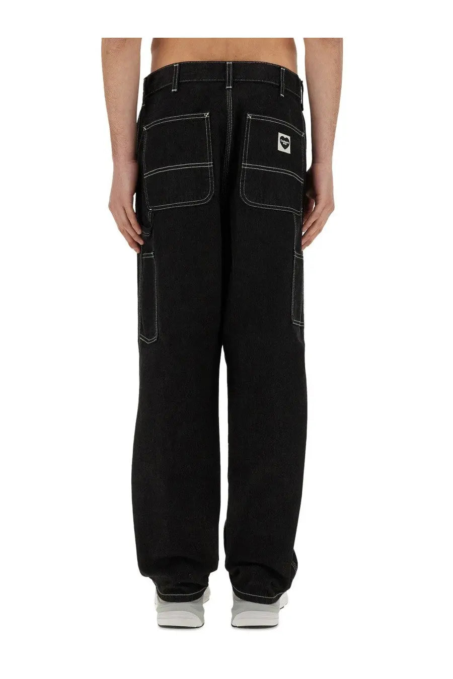 Back view of carhartt Wip men’s black single knee cargo pants with white stitching and logo patch on right pocket