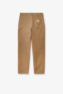 Back view of tan carhartt wip men’s single knee work pants with multiple pockets and branded patch on right pocket