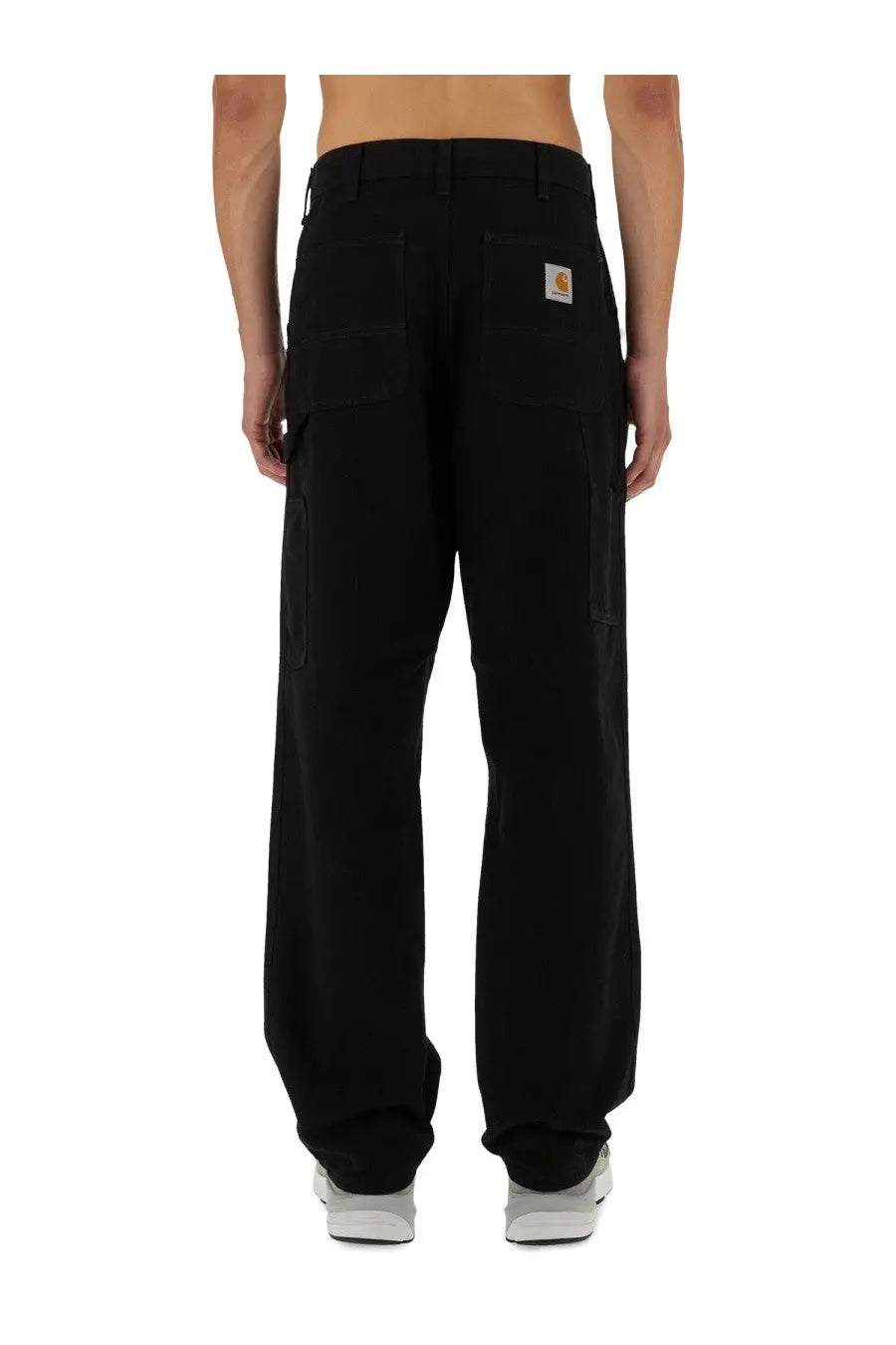 Black carhartt wip men’s single knee cargo pants with multiple pockets and branded patch on back waistband