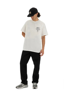 White carhartt t-shirt with black logo and text on chest paired with carhartt wip men’s single knee black pants